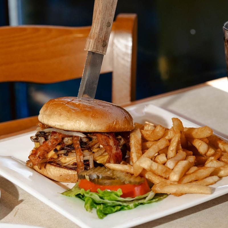 A bacon burger with a side of fries